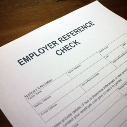 A close-up of a clipboard with a checklist, for an employee reference check process in a professional setting.